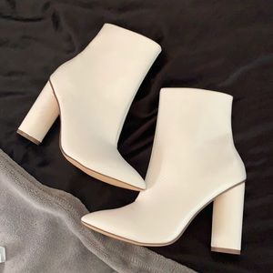 White pointed toe heeled boots
